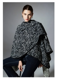 Detail of premium black and white geometric patterned knit cape with soft mink texture
