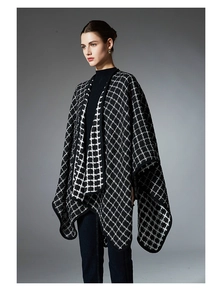 Detail of classic black and white plaid pattern knit poncho with high-quality edge stitching
