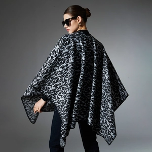 Women's black and white leopard print knit shawl with a draped oversized silhouette