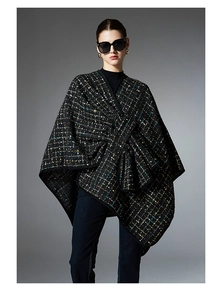 Detail of tweed checkered shawl featuring a large bow and colorful glitter sequins