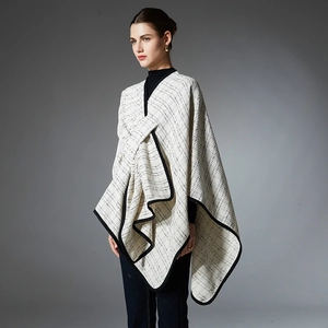Women's plaid wrap shawl with black trim and elegant draped silhouette design