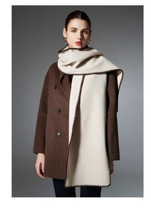 Detail of solid color winter scarf with decorative brown scalloped stitched edges