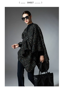Detail of black tweed shawl with colorful sequins and elegant woven edge trim