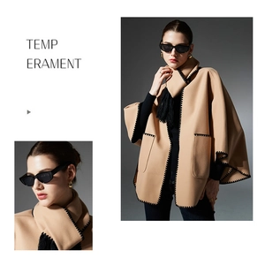 Detail of camel wool poncho showing black scalloped stitch edges and tassel drawstring
