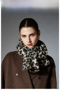 Detail of premium leopard print scarf with whipstitched edges on wool coat