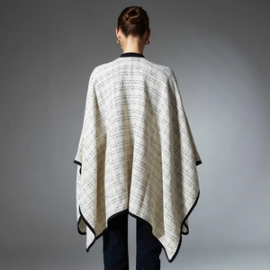 Back view of elegant plaid poncho cape for women in beige and black knit fabric