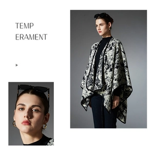 Detailed view of women's knit shawl with black and white abstract ink painting patterns