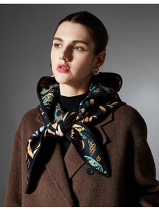 Detail of paisley pattern on French style hooded cloak scarf with thick velvet texture