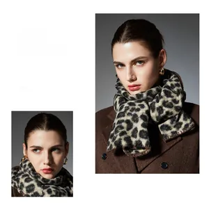 Close-up of leopard print scarf with premium hand-stitched edges and green accents