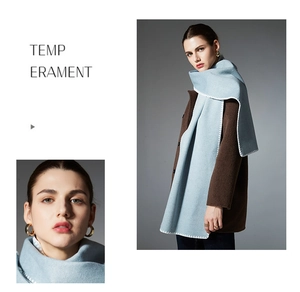 Detail of light blue scarf with white decorative stitching paired with a brown wool coat