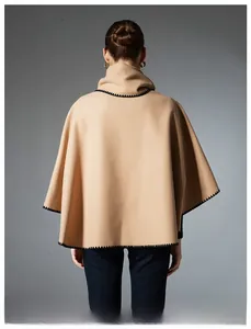 Back view of elegant camel cape shawl with high collar and black embroidered stitching details