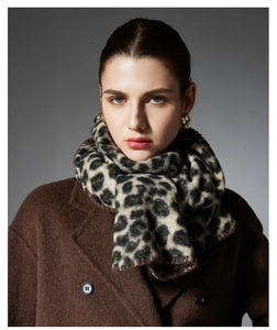 Close-up of leopard print scarf with fine stitching texture on wool coat background