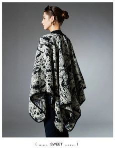 Detail of soft knit faux fur shawl with black and white abstract ink art pattern