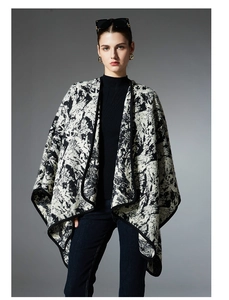 Detail of artistic black and white ink wash pattern on knit winter shawl for women