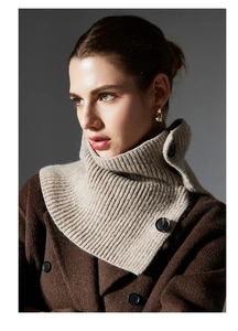 Detail of beige ribbed wool knit neck warmer with button closures on a model