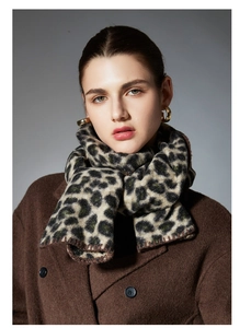 Close-up of premium leopard print scarf featuring hand-stitched edges and soft texture