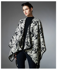 Detailed view of black and white ink painting pattern on knit shawl wrap for women