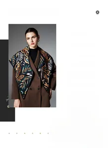 Detail of autumn paisley leaf jacquard shawl styled with a wool double-breasted coat