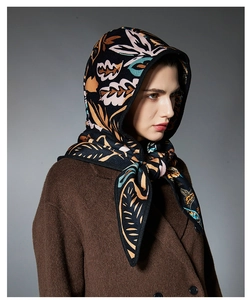 Close-up of vintage paisley pattern on black hooded scarf for autumn and winter