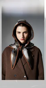 Detailed view of women's plaid hooded shawl with wool texture and classic checkered pattern