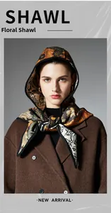Close-up of floral hooded shawl with vintage botanical pattern and black piping finish