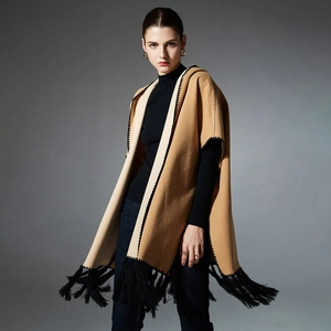 Elegant camel knit poncho with black wavy trim, fringe hem and hood for winter