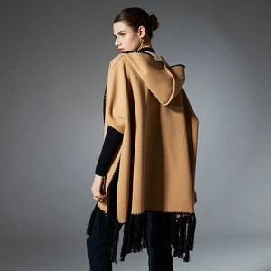Women's camel hooded cloak with black embroidery and fringe tassels shown from the back