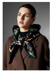 Detail of French vintage paisley bandana scarf styled with a classic wool coat