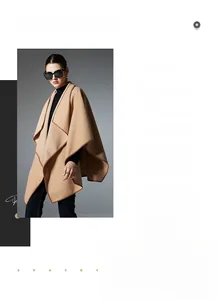 Detail of camel colored shawl with contrasting dark brown piping and structured fabric draping