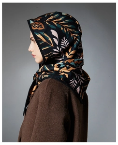 Detailed texture of paisley pattern hood scarf paired with a wool coat