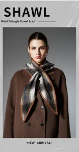 Detailed view of the plaid wool blend triangular shawl with brown knitted lockstitch edge