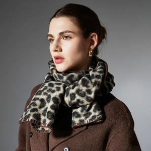 Women's warm autumn leopard print knit scarf styled with a brown wool coat and jewelry