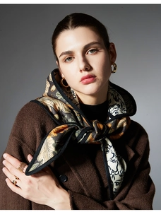 Detail of vintage floral jacquard scarf shawl paired with brown wool coat and jewelry