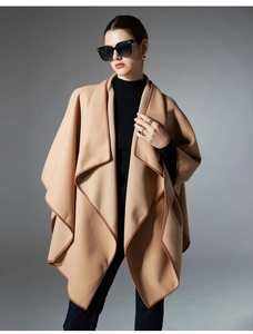 Detail of camel wool shawl featuring premium dark brown leather piped edges and lapel style