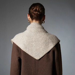 Brown wool coat with beige knitted hooded triangle shawl shown from a back view