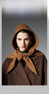 Detailed view of dark brown hooded shawl scarf in premium textured wool fabric