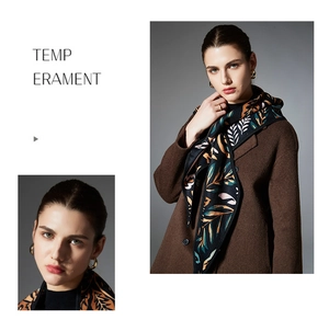 Detail of luxury paisley leaf jacquard scarf styled with brown wool coat for winter