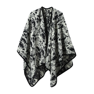 Knit shawl wrap with artistic black and white ink wash pattern and contrast trim