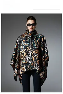 Detail of colorful leaf patterns and contrast white stitching on a black poncho