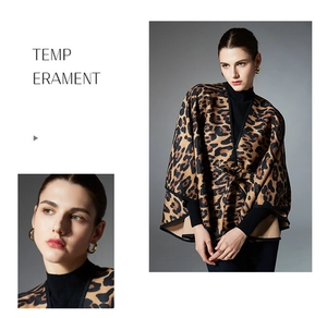 Detail of leopard print shawl featuring waist belt and elegant black trim borders