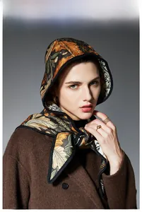 Detailed view of luxury jacquard silk scarf with vintage floral patterns and warm tones