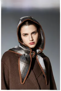 Detail of plaid hooded wool shawl with premium texture and grey-brown check pattern