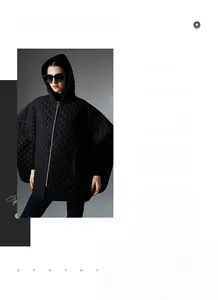 Detail of black quilted hooded poncho with diamond pattern and front metal zipper