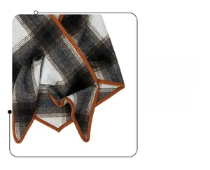 Detail shot of the brown hem edge and grey plaid wool texture on the winter scarf