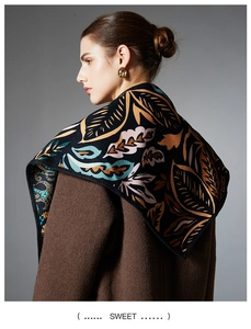Detailed view of autumn scarf with leaf jacquard pattern and premium knit texture