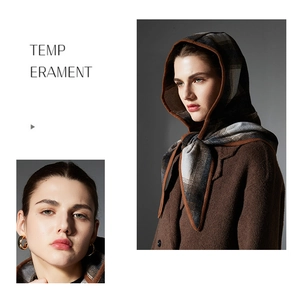 Detail of plaid wool balaclava scarf featuring premium brown knit texture and hood