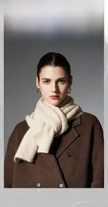 Close-up of premium cream-colored wool blend knitted shawl with subtle melange texture