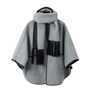 Gray woolen poncho shawl with black fringe tassel and decorative zigzag stitching edges