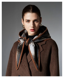 Detail of checkered hood scarf and dark brown wool coat with premium textured finish