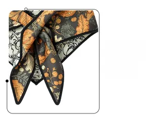 Detail shot of a floral triangle scarf showing soft silk texture and orange leaf patterns